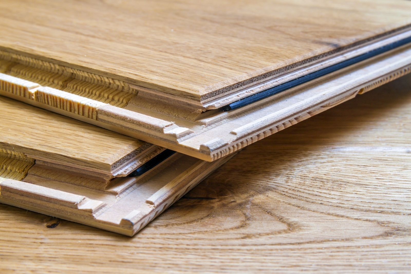 Brown wooden parquet floor planks installation , close up. Carpentry concept. Brown wooden parquet floor planks installation , close up. Carpentry concept.